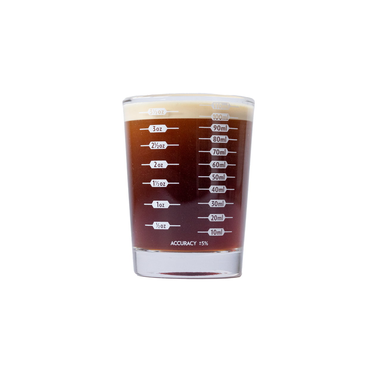 Measurement side of the shot glass, ounce and milliliter lines from 1/2 oz to 3 1/2 oz, filled with espresso.
