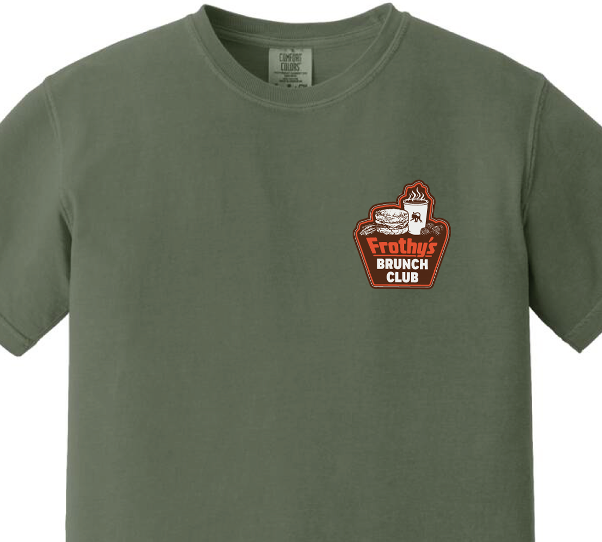 Front of the Frothy's Brunch Club T-shirt, small left chest badge on a sage green Comfort Colors shirt