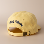 Back of the banana yellow Frothy Monkey Kong dad hat showing the Frothy Monkey script logo embroidered in navy across the rear panels and the matching cotton adjustable strap with brass clasp