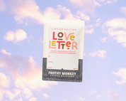 Love Letter Limited Edition coffee bag floating against pastel sunset clouds, showing colorful typography and gift label fields, 12 oz Valentine's coffee