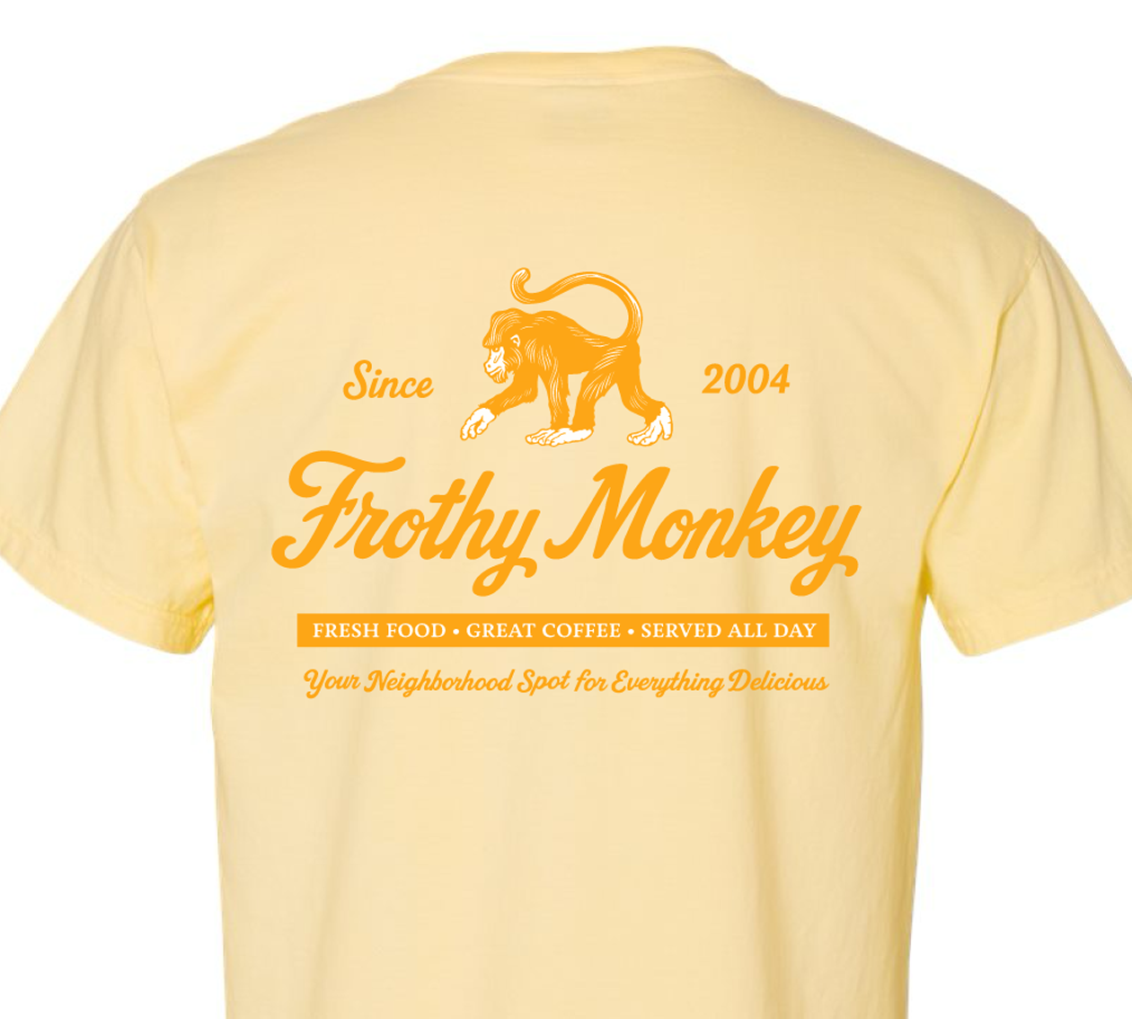 Frothy Monkey vintage logo tee in Banana Yellow showing full back graphic with Since 2004 monkey logo, Fresh Food Great Coffee Served All Day text, and Your Neighborhood Spot for Everything Delicious tagline in Brunch Yellow on Comfort Colors 1717