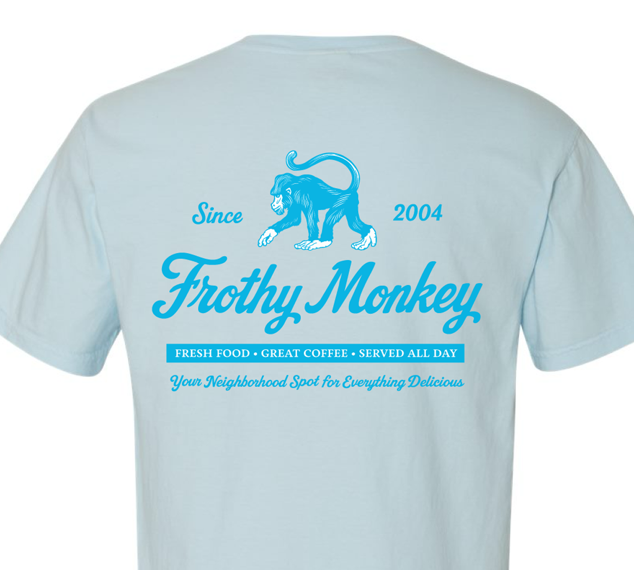 Frothy Monkey vintage logo tee in Sky Blue showing full back graphic with Since 2004 monkey logo, Fresh Food Great Coffee Served All Day text, and Your Neighborhood Spot for Everything Delicious tagline in Howler Blue on Comfort Colors 1717