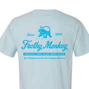 Frothy Monkey vintage logo tee in Sky Blue showing full back graphic with Since 2004 monkey logo, Fresh Food Great Coffee Served All Day text, and Your Neighborhood Spot for Everything Delicious tagline in Howler Blue on Comfort Colors 1717