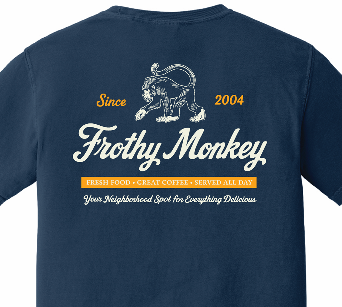 Back of the Frothy Monkey vintage logo tee in True Navy, cream monkey and script logo above a marigold Fresh Food, Great Coffee, Served All Day banner