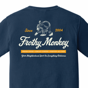 Back of the Frothy Monkey vintage logo tee in True Navy, cream monkey and script logo above a marigold Fresh Food, Great Coffee, Served All Day banner