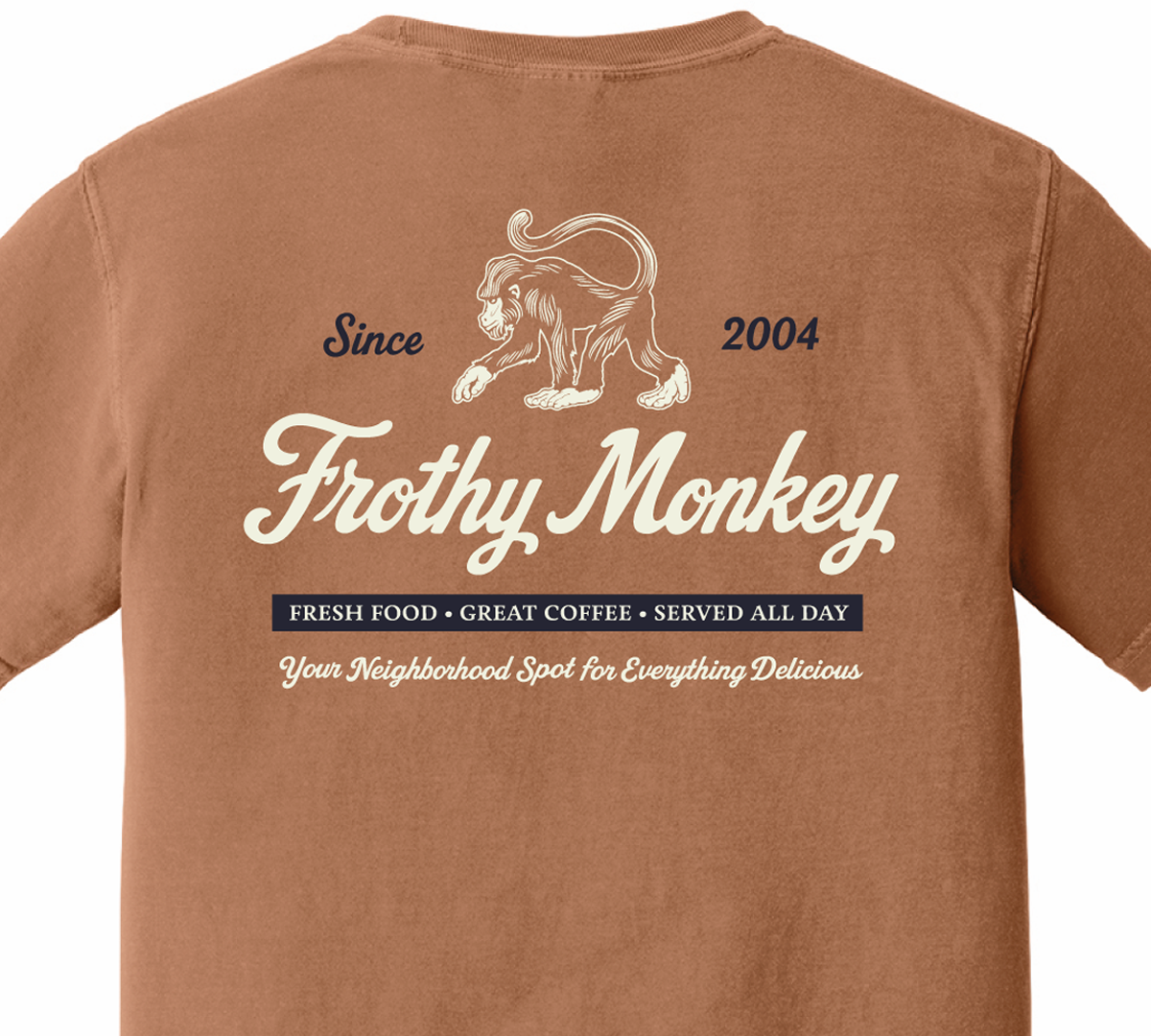 Back of the Frothy Monkey vintage logo tee in Yam, cream monkey and script logo above a navy Fresh Food, Great Coffee, Served All Day banner