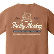 Back of the Frothy Monkey vintage logo tee in Yam, cream monkey and script logo above a navy Fresh Food, Great Coffee, Served All Day banner