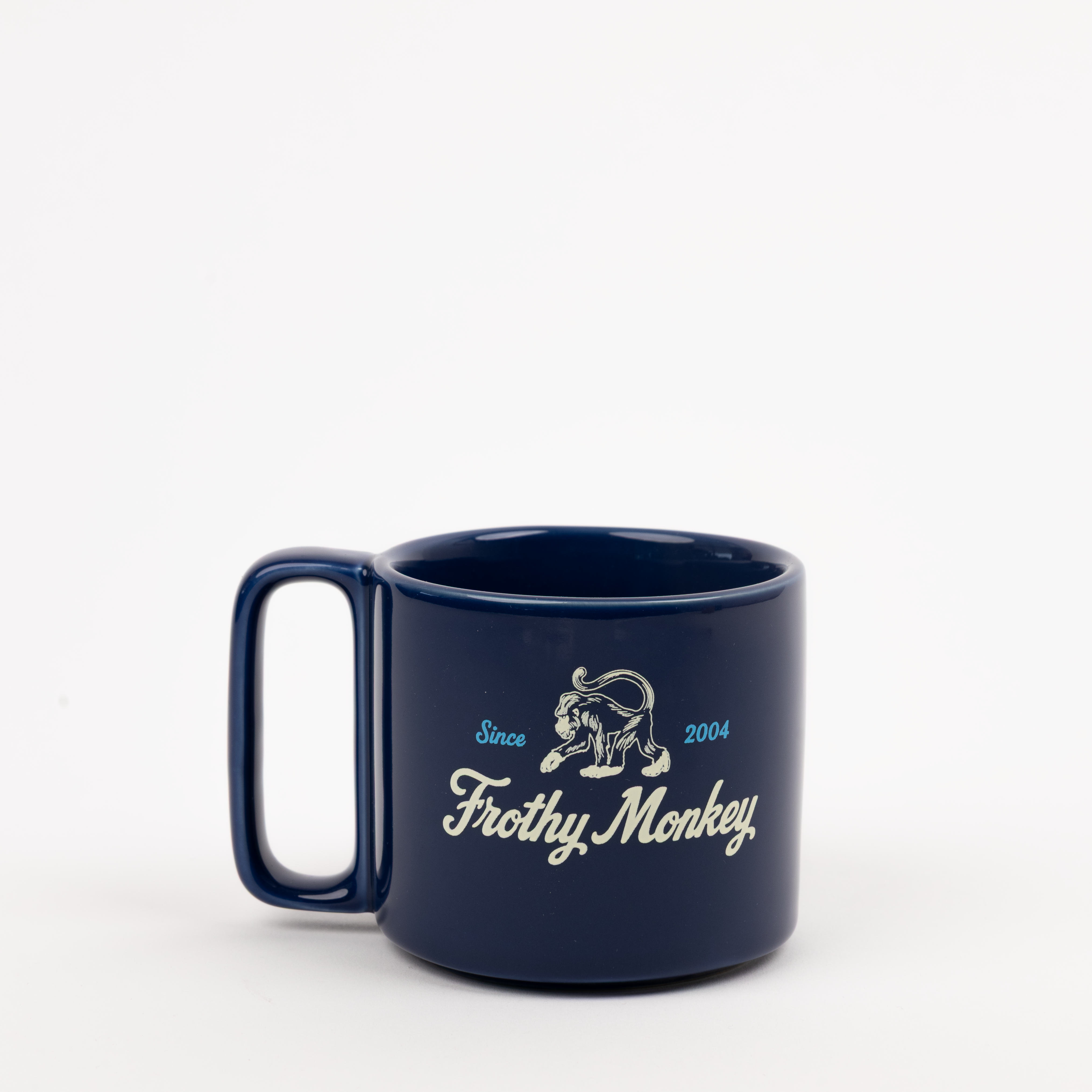Single Frothy Monkey 10 oz stackable ceramic mug in Navy Blue with vintage logo in cream and Howler Blue accents, side view