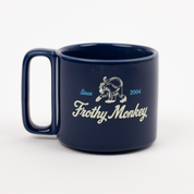 Single Frothy Monkey 10 oz stackable ceramic mug in Navy Blue with vintage logo in cream and Howler Blue accents, side view