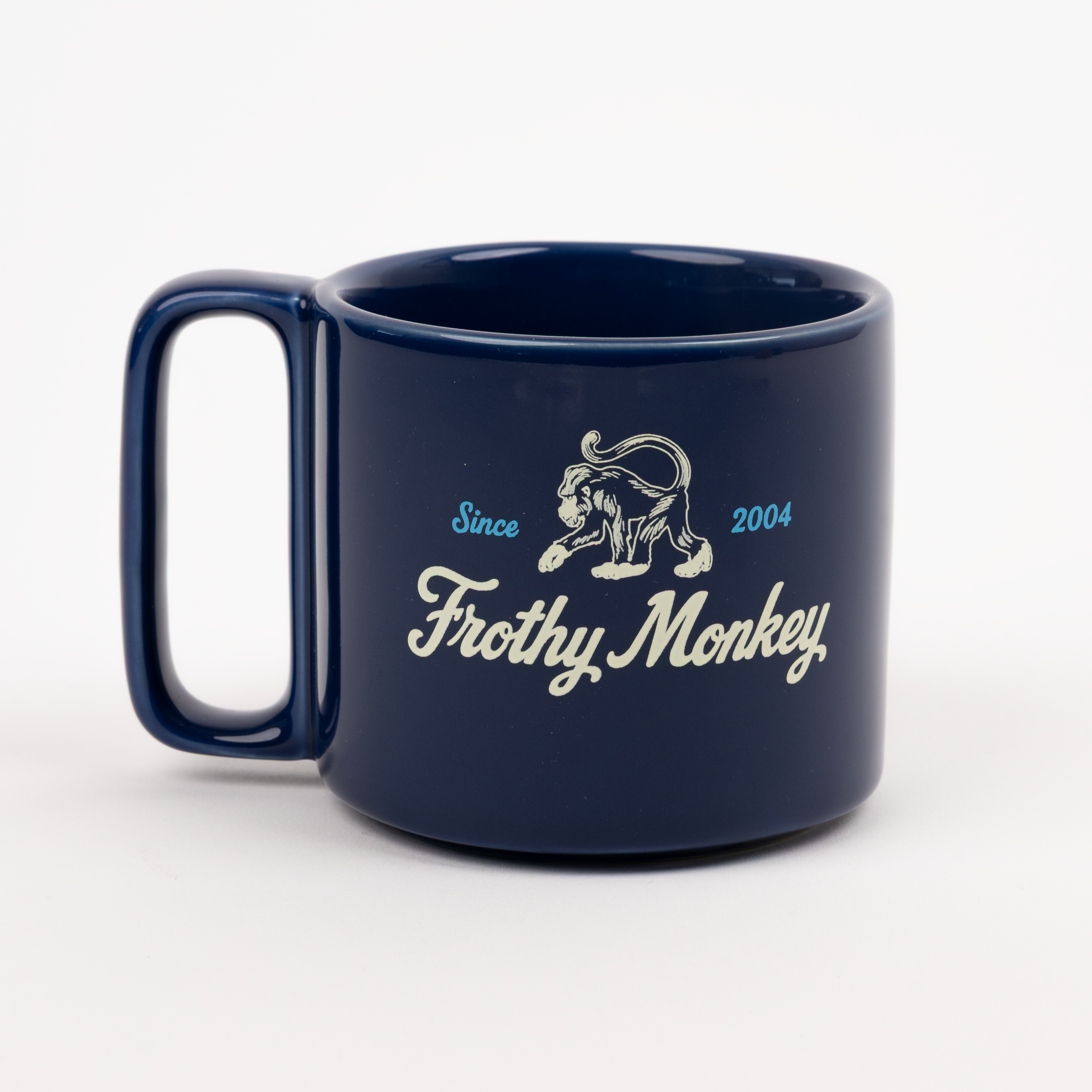 Single Frothy Monkey 10 oz stackable ceramic mug in Navy Blue with vintage logo in cream and Howler Blue accents, side view