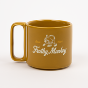 Single Frothy Monkey 10 oz stackable ceramic mug in Chai with vintage logo in cream and Brunch Yellow accents, side view