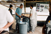 Andres Cardona talking with a visitor beside fermentation tanks at La Ilusion, Santa Barbara, Colombia