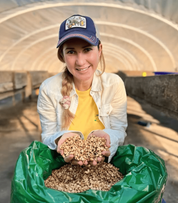 Producer Katia Duke holding parchment coffee in a drying greenhouse at San Isidro, Copán, Honduras